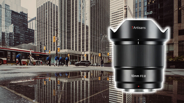 Artisans 10mm f2.8 ultra-wide lens product shot displayed over urban street reflection